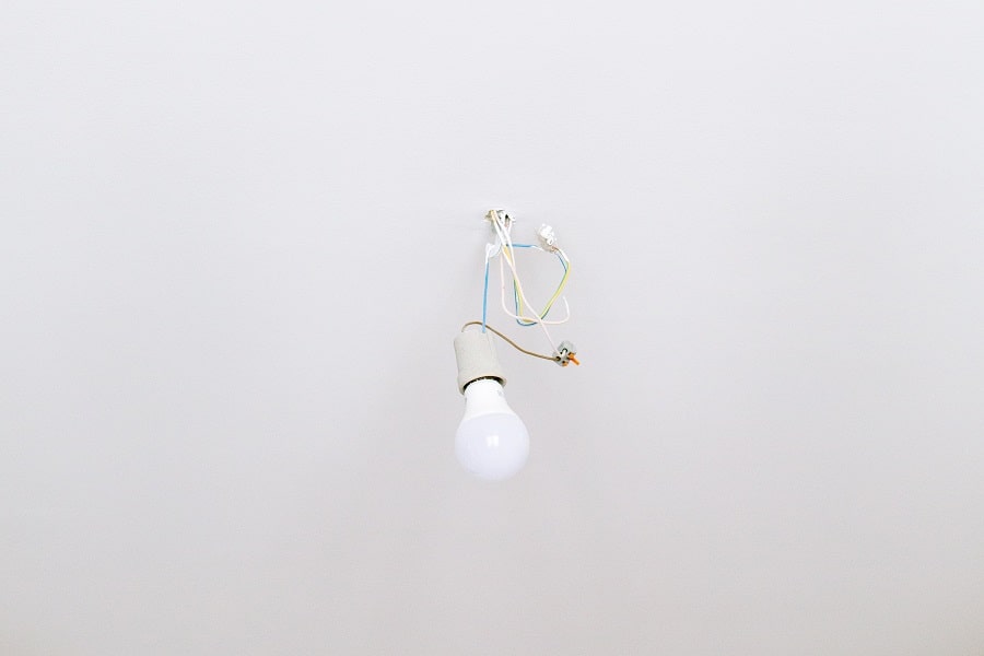Best Electrical Contractor in Boca Raton Florida Close Up of a Light Bulb Attached to Wires Sticking Out of a Ceiling 