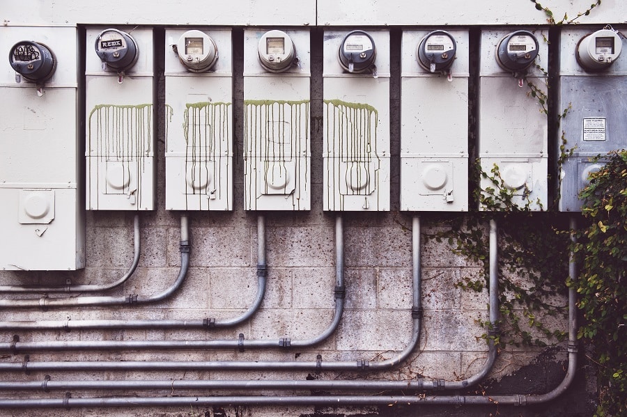 Best Rated West Palm Beach Electrician Close Up of a Row of Power Meters on a Brick Wall