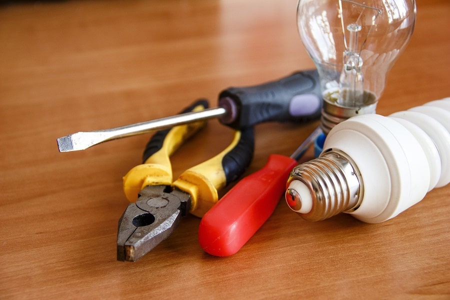 Electrical Contractor in Boynton Beach Florida Close Up of Tools and Two Light Bulbs