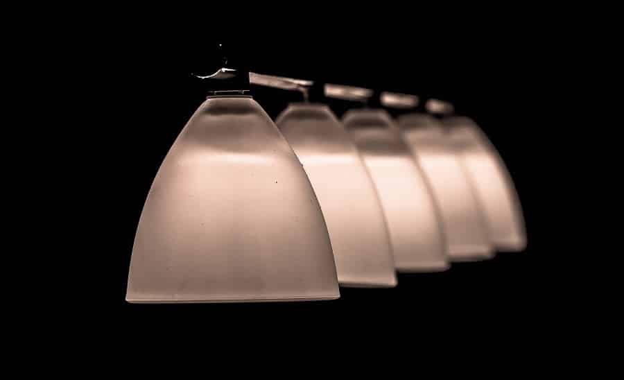 Electrical Contractor in Palm City Florida Close Up of a Row of Pendant Light Fixtures Turned on in a Dark Room