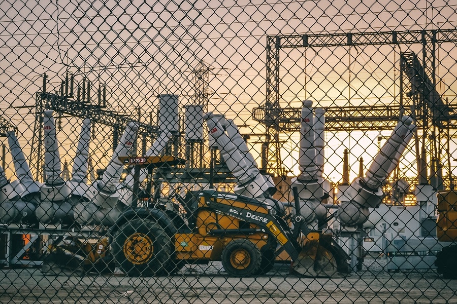 Electrical Contractor in Stuart Florida View of a Power Plant with Construction Vehicles Parked on the Lot