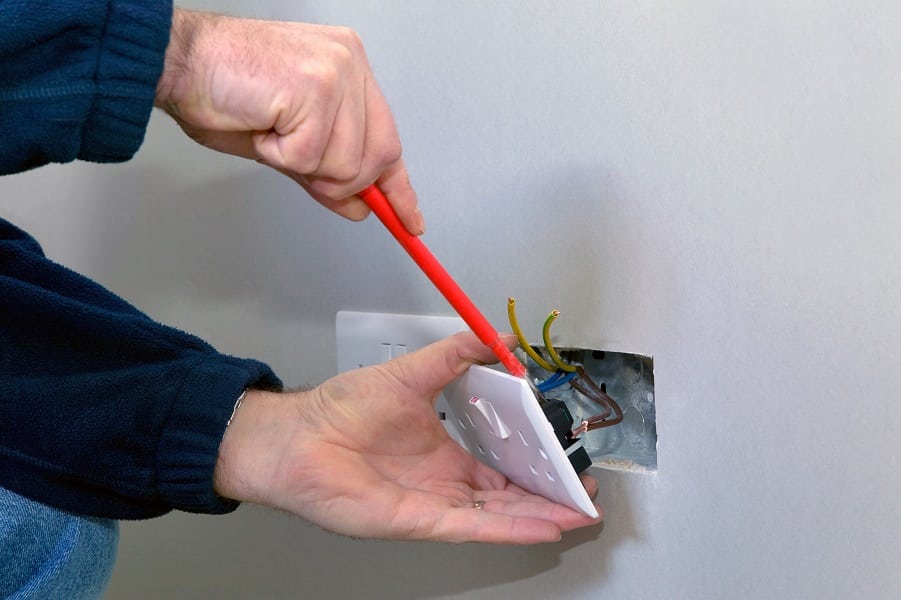Electrical Contractor in Palm Beach Gardens Florida Close Up of an Electrician Installing an Outlet