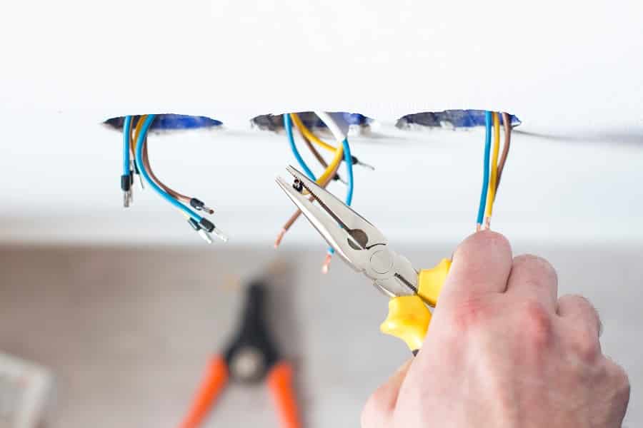 Male hands repair the socket