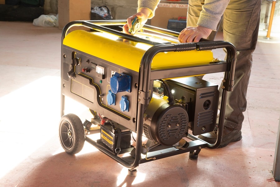 Why Should I Buy a Generator a Person Setting Up a Portable Generator in a Basement