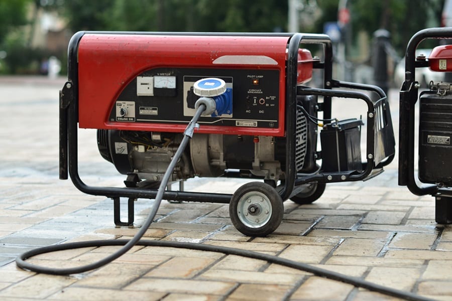 Why Should I Buy a Generator Close Up of a Portable Generator on Bricks