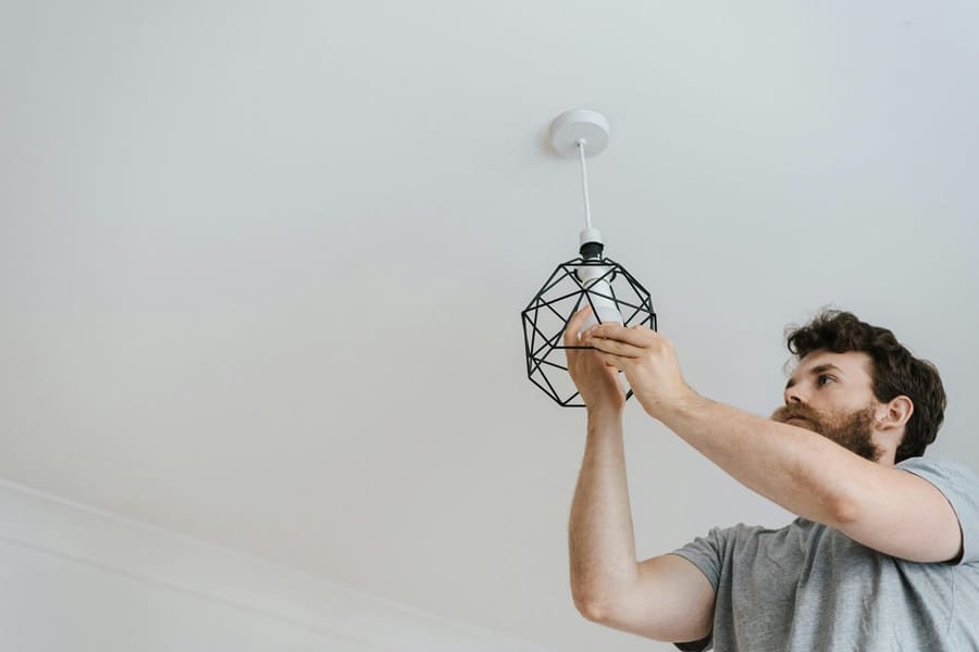 Best Electrician in Stuart Florida an Electrician Installing a New Pendant Light Fixture in a Home