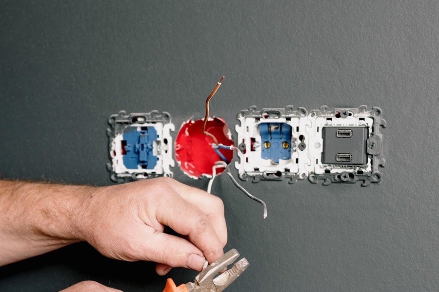 Best Electrician in Stuart Florida Close Up of an Electrician Working on an Outlet Installation