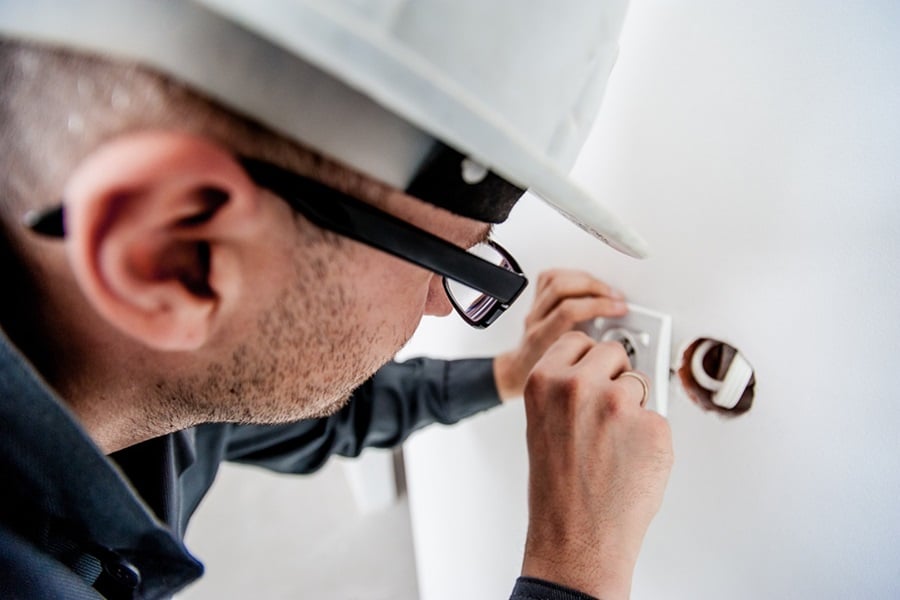 Best Electrician in Jupiter Florida an Electrician Working on a Outlet Installation
