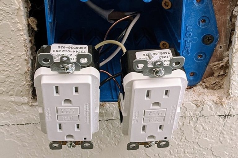 Best Home Surge Protection Electrician in Hobe Sound Close Up of an Outlet Hanging from a Wall Before Installation
