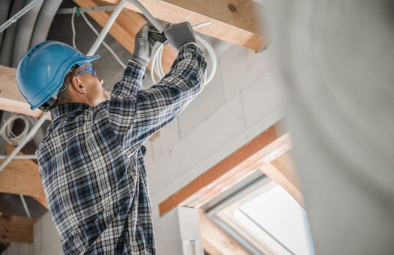 Best Electrician Near Me Delray Beach Construction Electric Contractor Worker Installing Ceiling Light Point. Caucasian Electrician at Work. Industrial Theme.