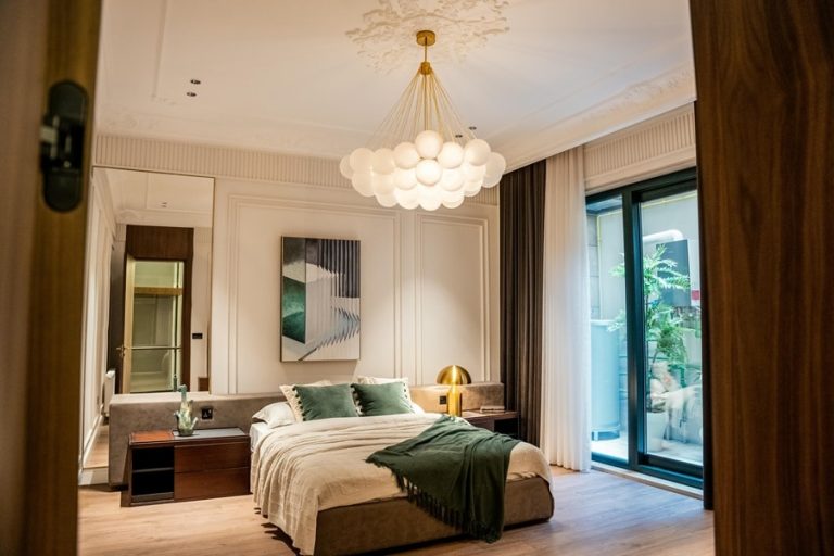 Best Chandelier Installation Electrician in Palm Beach County a Chandelier Hanging in a Bedroom Over a Room