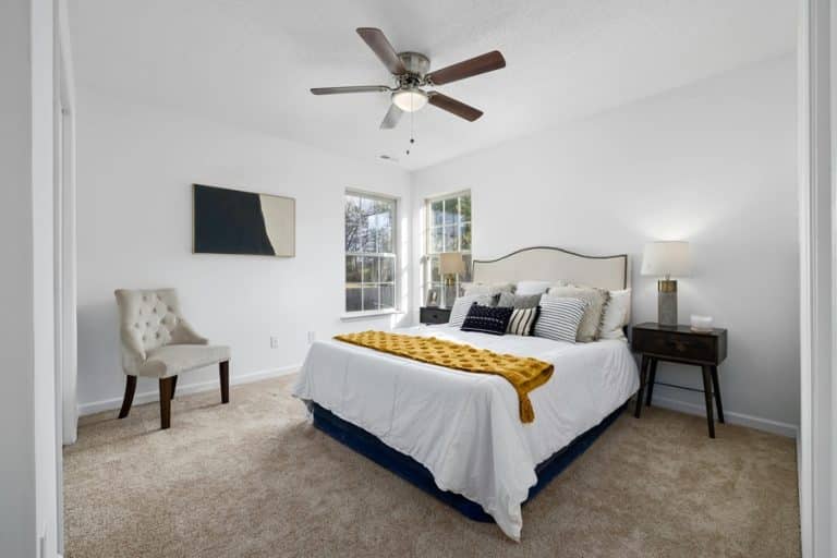Best Ceiling Fan Installation Electrician in Greenacres a Bedroom with a Bed, a Nightstand, and Chair and a Ceiling Fan