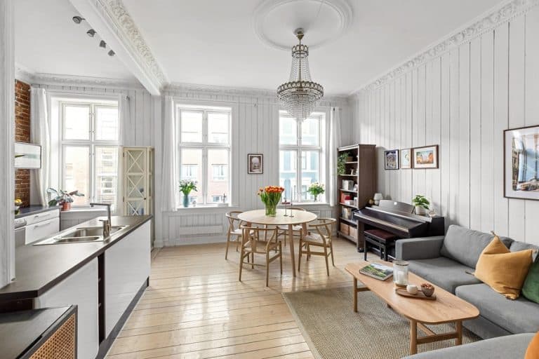 Best Chandelier Installation Electrician in Sewall's Point Florida a Chandelier Hanging Above a Family Room with a Couch, Coffee Table, Small Breakfast Table, and a Bookcase