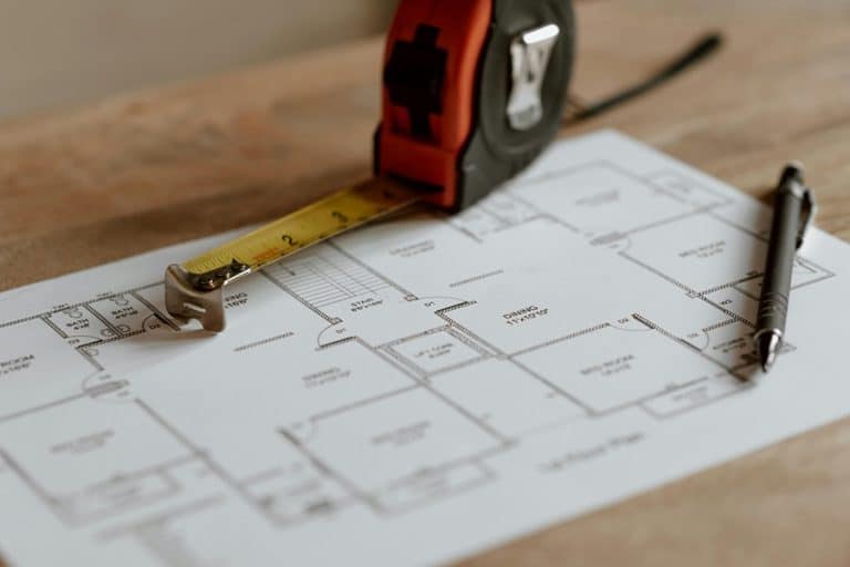 Best Home Remodel Electrician in Loxahatchee Groves Close Up of Blueprints with a Tape Measure on Top