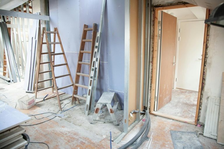 Best Home Remodel Electrician in Loxahatchee The Acreage Two Ladders Against a Wall in a House with Tarping Down on the Floor