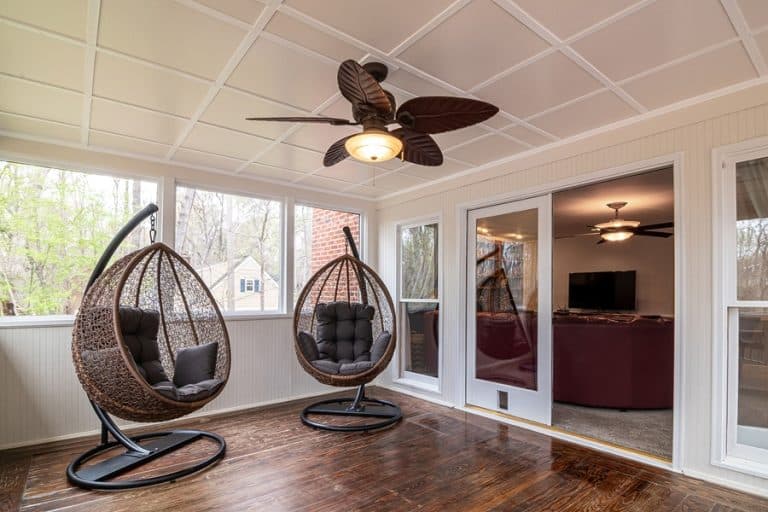 Best Equestrian Club Estates Ceiling Fan Installation Electrician a Ceiling Fan Hanging Above Two Swinging Chairs in a Lanais