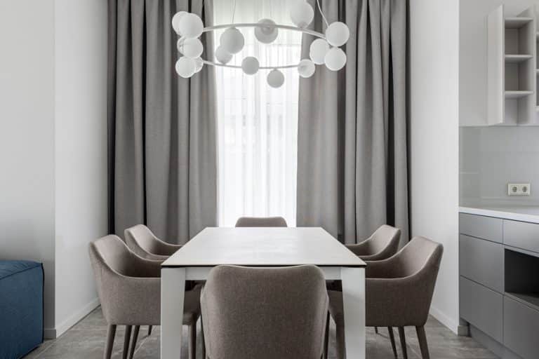 Best Chandelier Installation Electrician in Hobe Sound Florida a Modern Chandelier Hanging Above a Dining Table