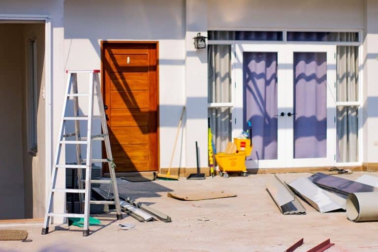 Best Home Remodel Electrician in Stuart Florida Tools and a Ladder Stacked Against the Outside Wall of a Home
