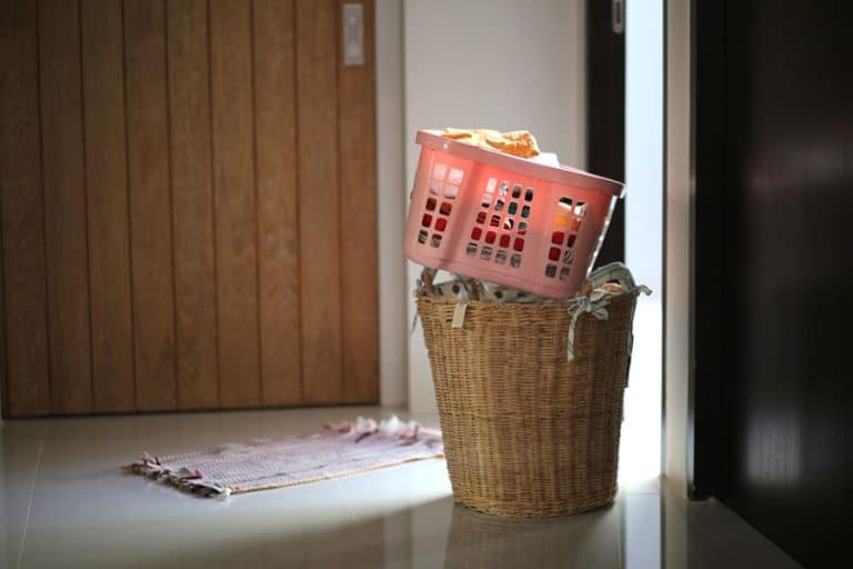Best Laundry Room Remodel Electrician in Jupiter Florida a Filled Laundry Basket Sitting Next to a Door in a Home