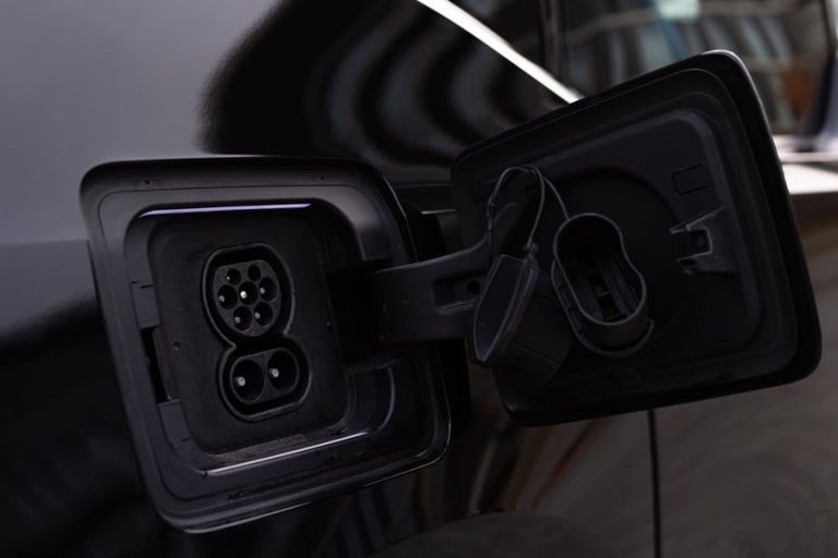 Best EV Charger Installation Electrician in Port Salerno Close Up of a Charging Port on a Black EV
