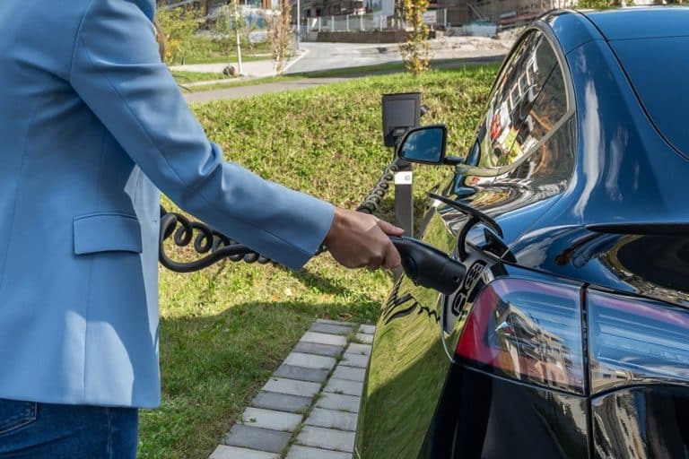 Best EV Charger Installation Electrician in Stuart a Person Plugging a Charger into an EV