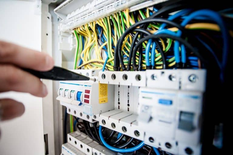 Best Electrician Near Me in Jensen Beach an Electrician Testing a Current on a Panel